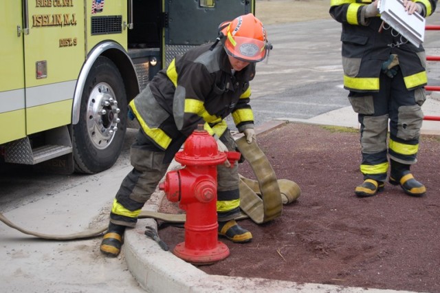 RJ McPartland hooking up to the hydrant at a live burn drill.